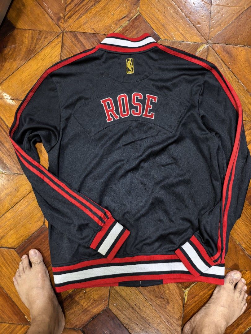 Adidas Derrick Rose Chicago Bulls Jacket (Category: Coats, Jackets and Outerwear) located in Manila. Submitted by snooks1938 (Listing ID 1437791912, Image 3). Description: For Grab!! NBA ADIDAS DERECK ROSE VARSITY JACKET BULLS. Size Medium.. 100% Authentic or money back.. - Adidas Chicago Bulls Derrick Rose jacket - Black base with red and white accents - Features "ROSE" on the back - Adidas and NBA logos - Zip-up style with collar Pm for any Que