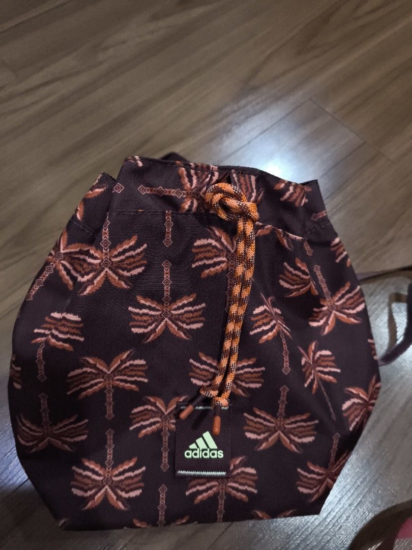 Adidas x Farm Rio mini bag (Category: Backpacks) located in Quezon City. Submitted by jhays02 (Listing ID 1437935496, Image 1). Description: - Adidas Ivy Park bag - Unique palm tree pattern - Drawstring closure - Convertible: backpack or tote - Adjustable straps - Spacious interior - Includes original tag with model name and price - Stylish and versatile.