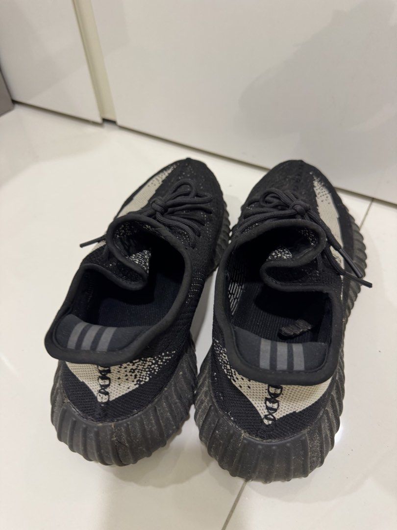 Adidas Yeezy Boost 350 V2 Black (Category: Sneakers) located in Singapore. Submitted by _misslemon (Listing ID 1437893726, Image 3). Description: - Significant wear and tear - Sole damage present - Priced to sell - Ideal for project or parts - Please view photos for condition details.