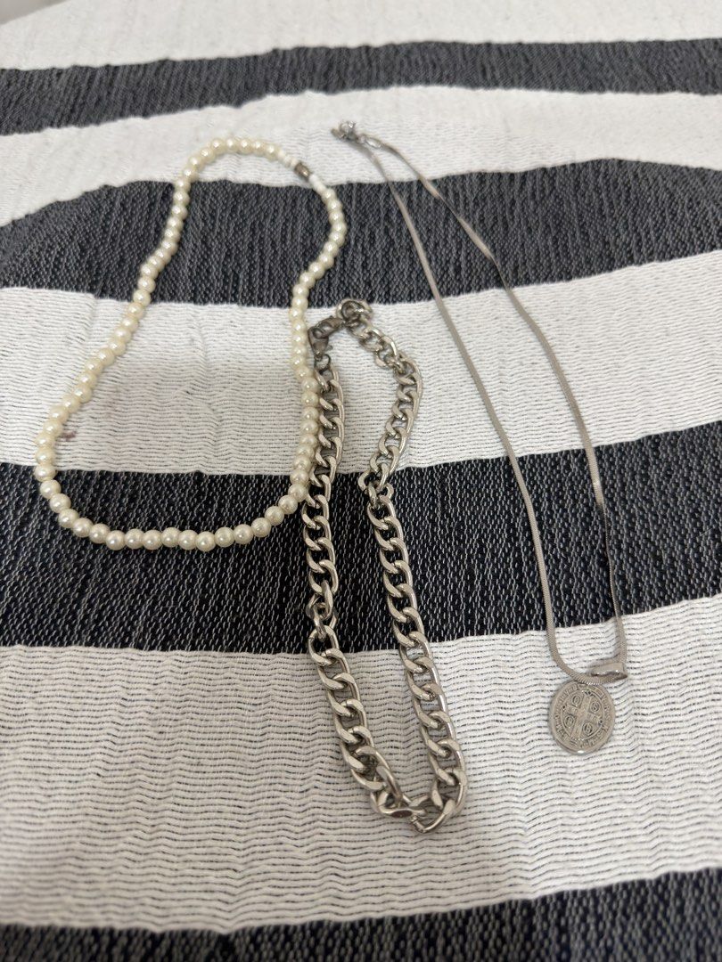 Assorted Necklaces - Pearl, Chain, and Coin Pendant (Category: Necklaces) located in Makati City. Submitted by turtletales (Listing ID 1437792263, Image 1). Description: - Set includes three necklaces: - Pearl necklace - Silver curb chain necklace - Silver necklace with coin pendant - All necklaces are made of metal. - Perfect for layering or individual wear..