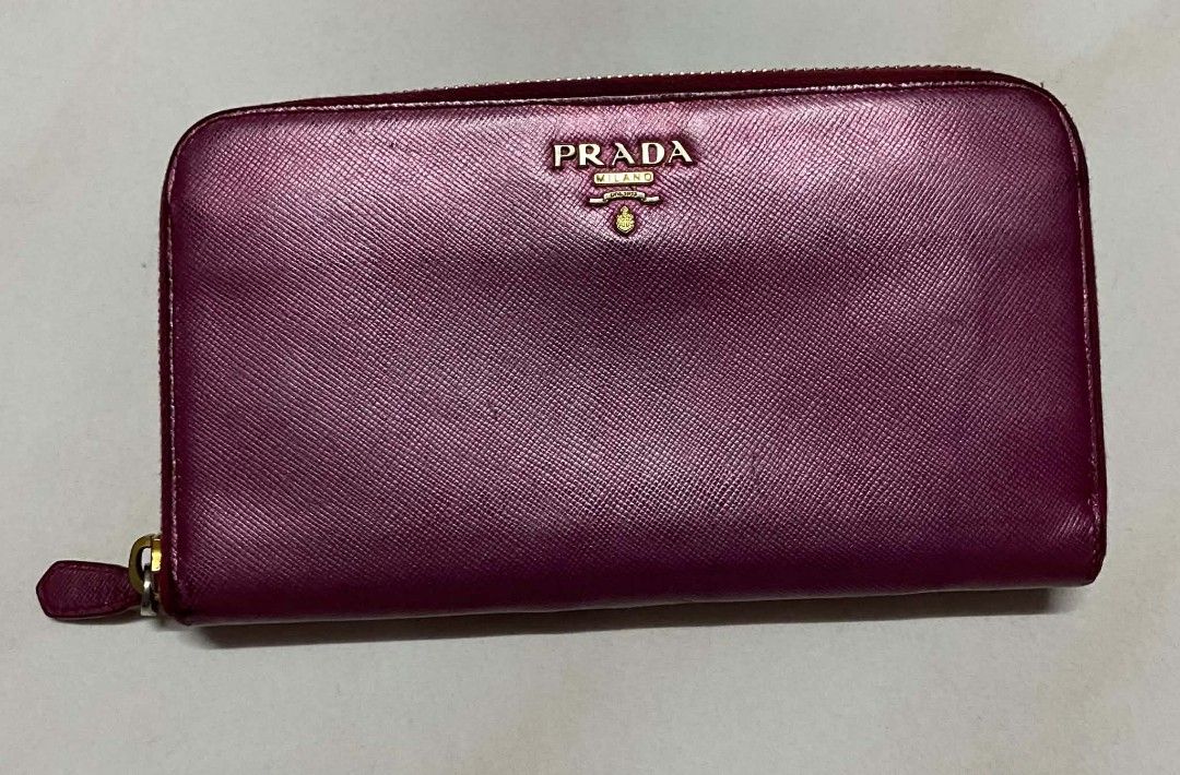 Authentic Prada Zip Around Wallet (Category: Luxury Bags & Wallets) located in Manila. Submitted by gutierrez23265 (Listing ID 1437805693, Image 1). Description: - Authentic Prada zip-around wallet - Stunning magenta color - Gold-tone zipper and hardware - Multiple card and cash compartments - Prada logo on front - Prada logo on zipper pull PLS CHECK ALL PHOTOS DETAILS BEFORE MAGMINE NO RETURN NO EXCHANGE PAYMENT FIRST ADD SF NO COP OR COD PAYMEN