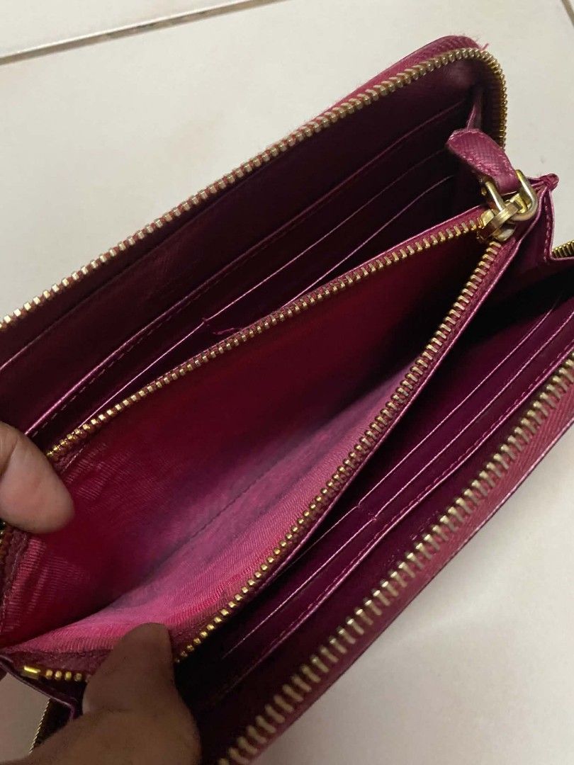 Authentic Prada Zip Around Wallet (Category: Luxury Bags & Wallets) located in Manila. Submitted by gutierrez23265 (Listing ID 1437805693, Image 3). Description: - Authentic Prada zip-around wallet - Stunning magenta color - Gold-tone zipper and hardware - Multiple card and cash compartments - Prada logo on front - Prada logo on zipper pull PLS CHECK ALL PHOTOS DETAILS BEFORE MAGMINE NO RETURN NO EXCHANGE PAYMENT FIRST ADD SF NO COP OR COD PAYMEN