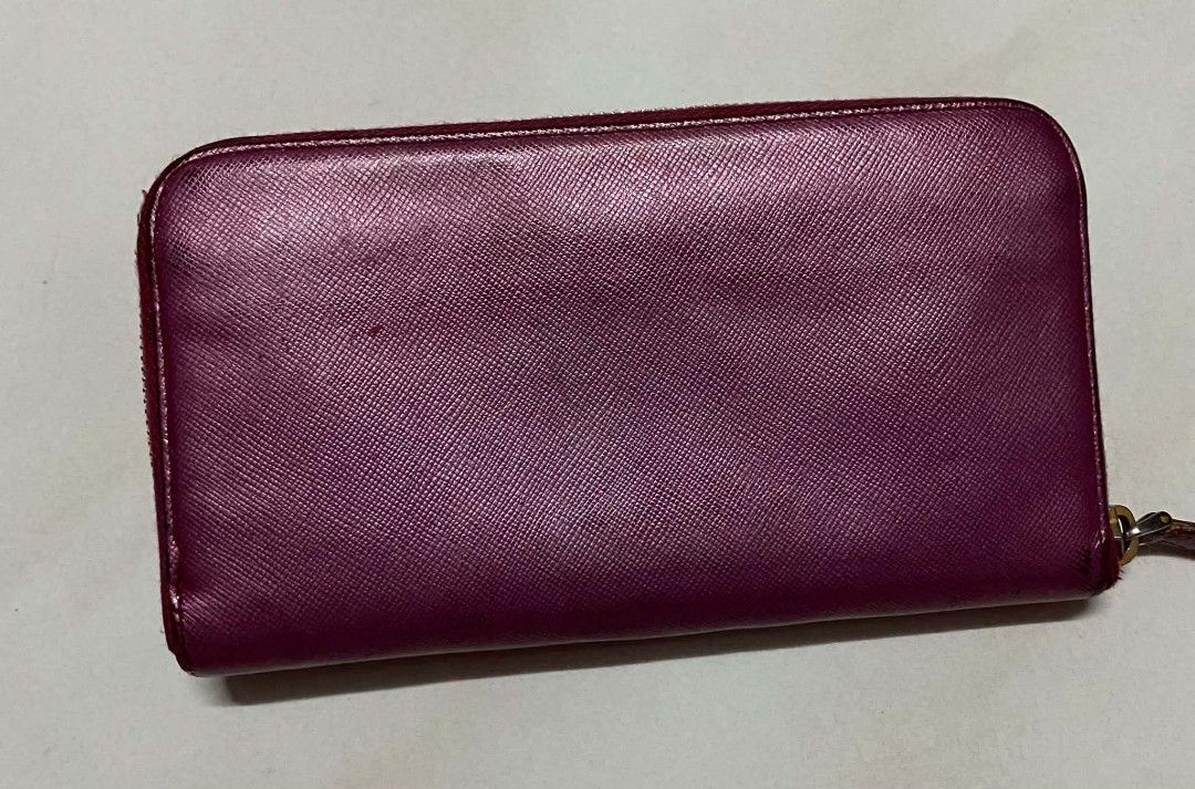 Authentic Prada Zip Around Wallet (Category: Luxury Bags & Wallets) located in Manila. Submitted by gutierrez23265 (Listing ID 1437805693, Image 2). Description: - Authentic Prada zip-around wallet - Stunning magenta color - Gold-tone zipper and hardware - Multiple card and cash compartments - Prada logo on front - Prada logo on zipper pull PLS CHECK ALL PHOTOS DETAILS BEFORE MAGMINE NO RETURN NO EXCHANGE PAYMENT FIRST ADD SF NO COP OR COD PAYMEN