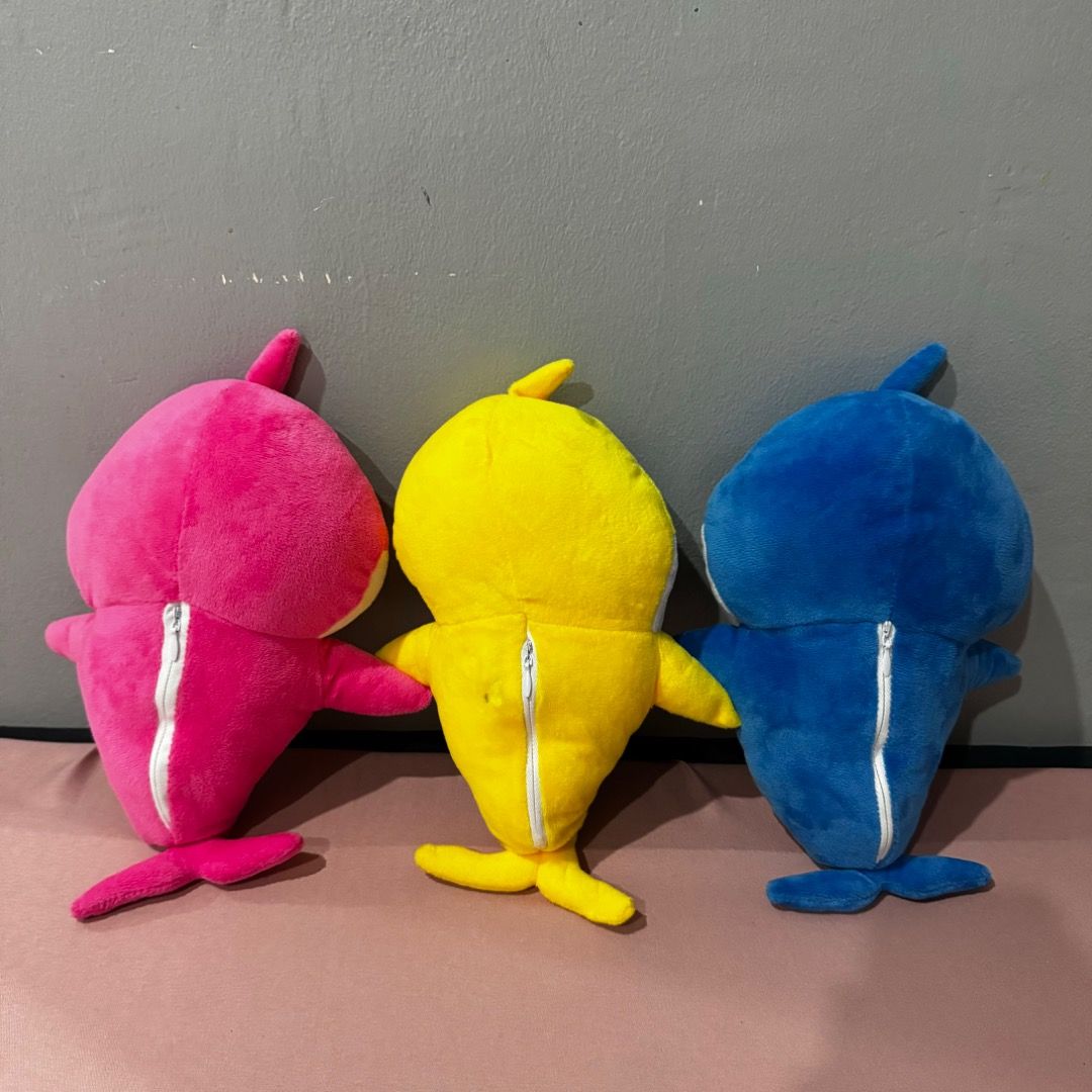 Baby Shark Plush Toys (Category: Plushies & Soft Toys) located in Manila. Submitted by louvemaria (Listing ID 1437857058, Image 2). Description: - 120 each - Set of 3 Baby Shark plush toys - Includes pink, yellow, and blue sharks - Each plush has a smiling face - Features arms and fins - Perfect for Baby Shark fans!.