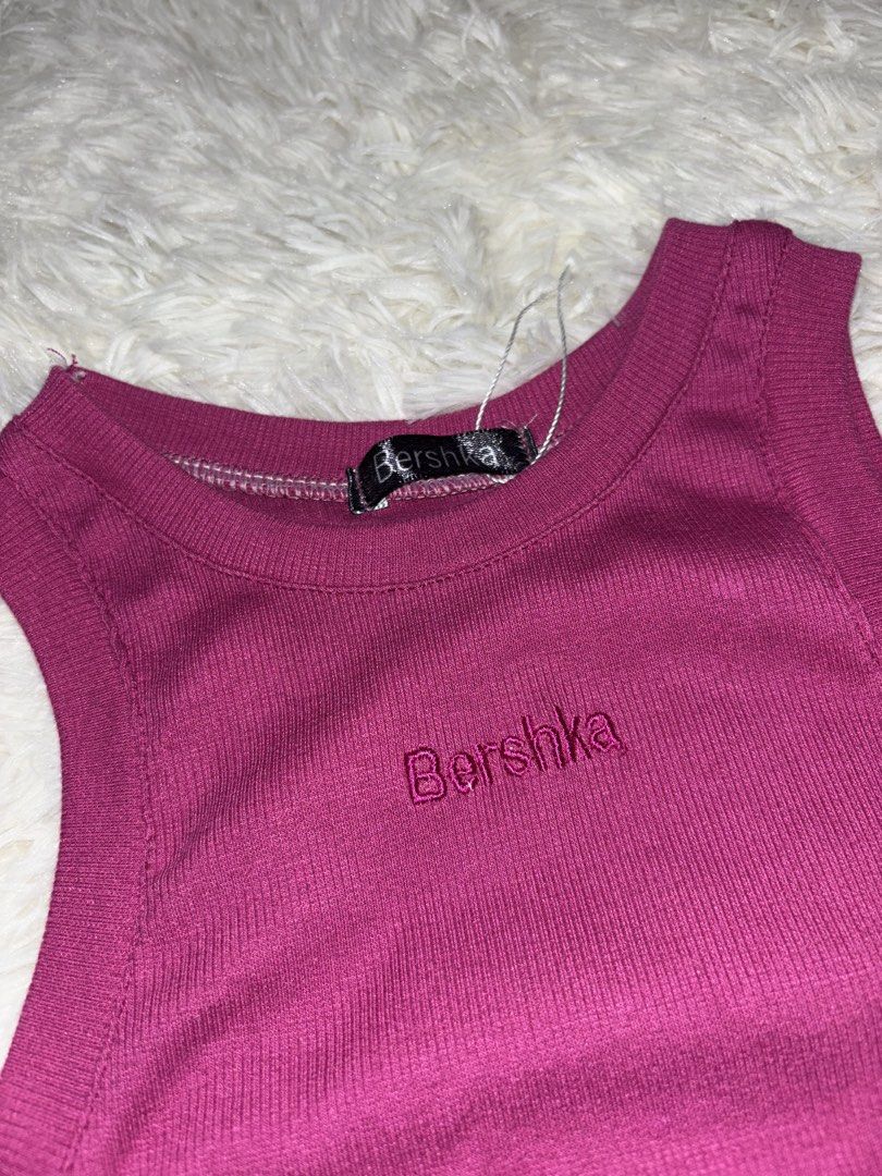 Bershka Ribbed Tank Top (Category: Sleeveless) located in Angono. Submitted by kalidope (Listing ID 1437921485, Image 2). Description: - Bershka tank top in vibrant magenta - Features a ribbed texture - Bershka logo embroidered on the front - Round neckline - Sleeveless design - Cropped style - Perfect for high-waisted bottoms - Brand new with tags.
