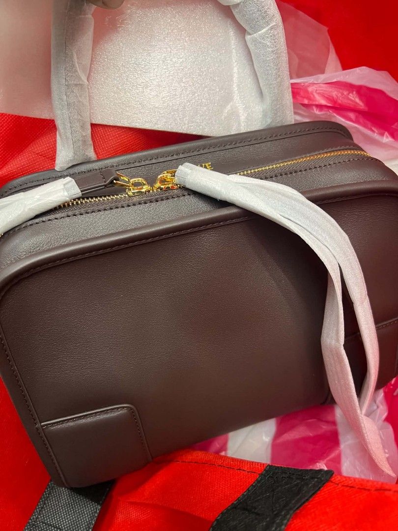Brown Leather Bag with Gold Zipper (Category: Shoulder Bags) located in Manila. Submitted by jet_luxph (Listing ID 1437775170, Image 1). Description: - Brown leather bag - Gold zipper - Rectangular shape - Structured design - Protective wrapping on handle and zipper - Includes handle.