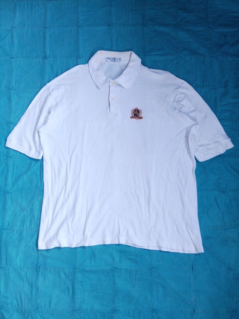 Burberrys White Polo Shirt (Category: Tshirts & Polo Shirts ) located in Las Pinas. Submitted by allhandpick (Listing ID 1437854332, Image 1). Description: - Burberrys white polo shirt - Embroidered Burberrys logo - 100% cotton - Made in England - Collared neckline - Short sleeves - Button-up placket.