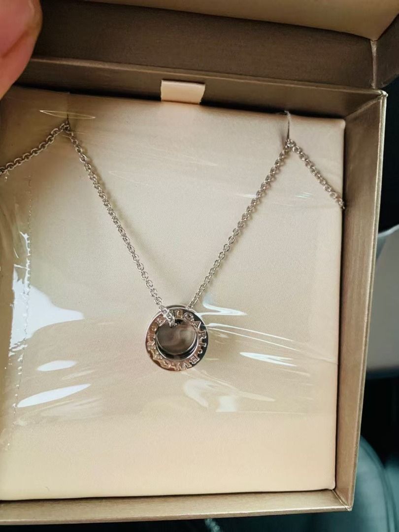 Bvlgari Necklace with Box (Category: Accessories) located in Singapore. Submitted by quickin (Listing ID 1437842116, Image 2). Description: - Authentic Bvlgari necklace. Have receipt - Comes with original box and paper bag - Features a circular pendant with the Bvlgari logo - Chain includes small circular details - Perfect for gifting or personal use.