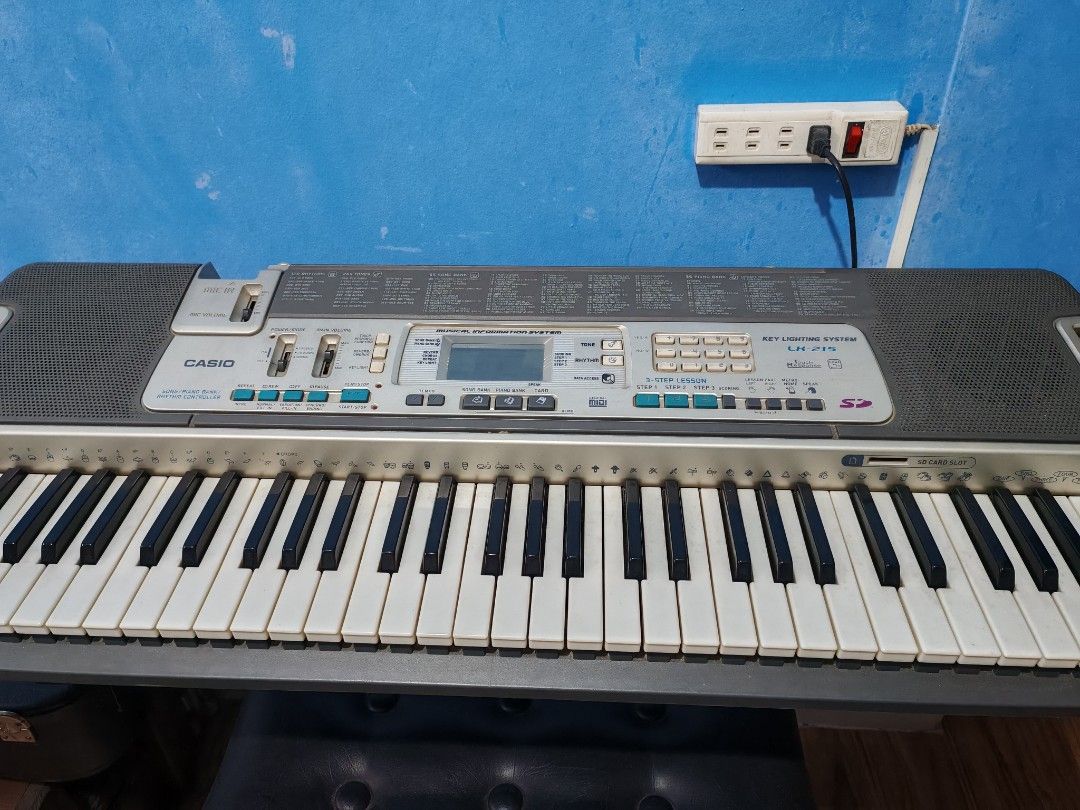 Casio LK-215 Keyboard with Bench (Category: Musical Instruments) located in Quezon City. Submitted by beautifulday.68 (Listing ID 1437795672, Image 3). Description: - Casio LK-215 keyboard and matching bench - Key lighting system - Musical information system - Digital display - Full set of keys - In good working order - Ideal for beginners and practice.