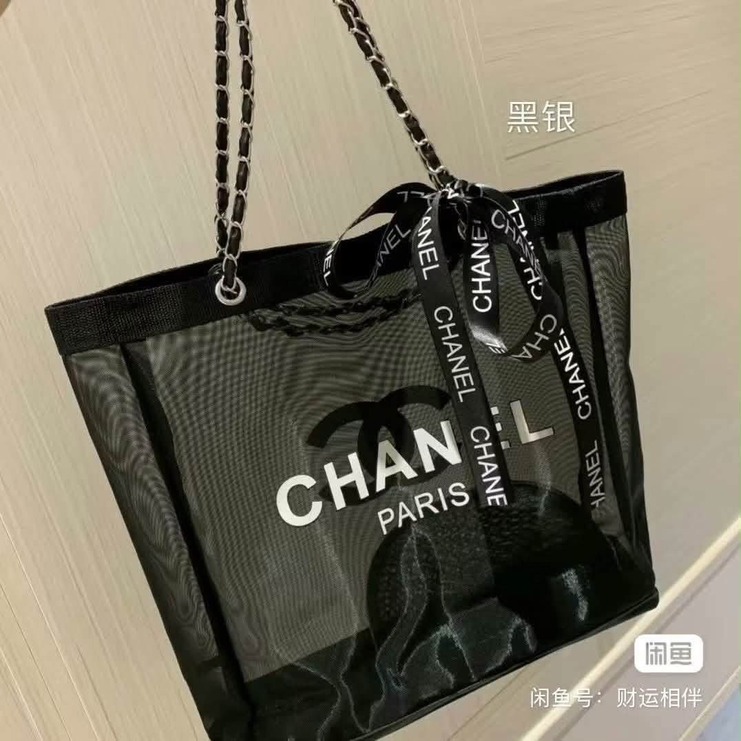 Chanel Mesh Tote Bag with Chain Strap (Category: Luxury Bags & Wallets) located in Iba. Submitted by geliqq (Listing ID 1437878940, Image 2). Description: - Chanel tote bag - Black mesh design - Chain strap - Includes matching pouch - Features large Chanel logo - Includes Chanel ribbon - Perfect for essentials - Adds a touch of luxury.