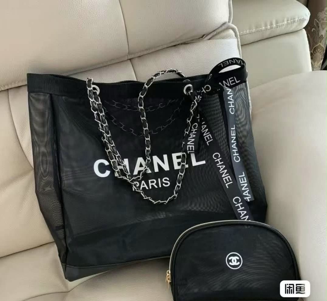 Chanel Mesh Tote Bag with Chain Strap (Category: Luxury Bags & Wallets) located in Iba. Submitted by geliqq (Listing ID 1437878940, Image 1). Description: - Chanel tote bag - Black mesh design - Chain strap - Includes matching pouch - Features large Chanel logo - Includes Chanel ribbon - Perfect for essentials - Adds a touch of luxury.