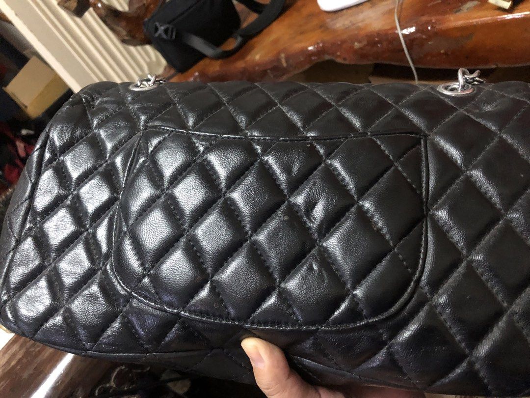 Chanel Quilted Shoulder Bag (Category: Luxury Bags & Wallets) located in Tabuk. Submitted by qurst (Listing ID 1437872135, Image 2). Description: - Black quilted shoulder bag - Silver chain straps - Flap closure with Chanel logo - Magnetic snap closure - Interior pocket and logo lining.