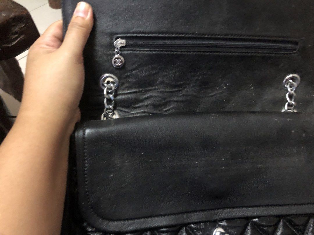 Chanel Quilted Shoulder Bag (Category: Luxury Bags & Wallets) located in Tabuk. Submitted by qurst (Listing ID 1437872135, Image 3). Description: - Black quilted shoulder bag - Silver chain straps - Flap closure with Chanel logo - Magnetic snap closure - Interior pocket and logo lining.