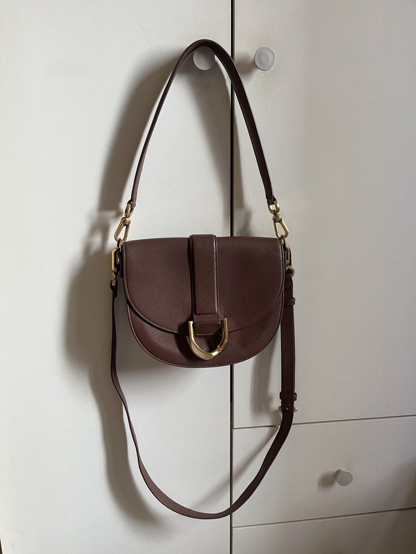 Charles & Keith Saddle Bag (Category: Cross-body Bags) located in Manila. Submitted by book.archives (Listing ID 1437796072, Image 1). Description: - Charles & Keith saddle bag - Elegant saddle bag design - Rich brown color - Flap closure with gold-tone buckle - Magnetic snap closure - Detachable and adjustable shoulder strap - Main compartment and zippered pocket inside.