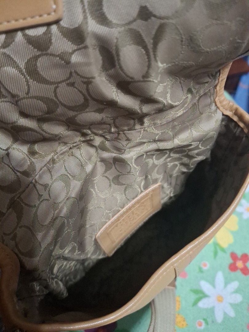 Coach Crossbody Bag (Category: Luxury Bags & Wallets) located in Quezon City. Submitted by lady.fox (Listing ID 1437848344, Image 3). Description: ***Please be reminded that the quality of the picture differs from the actual. Just message me once you need additional pictures or a video clip*** Tan Coach crossbody bag with a silver buckle closure. Features a beige adjustable strap. The interior lining has a Coach logo pattern. There is a small sta