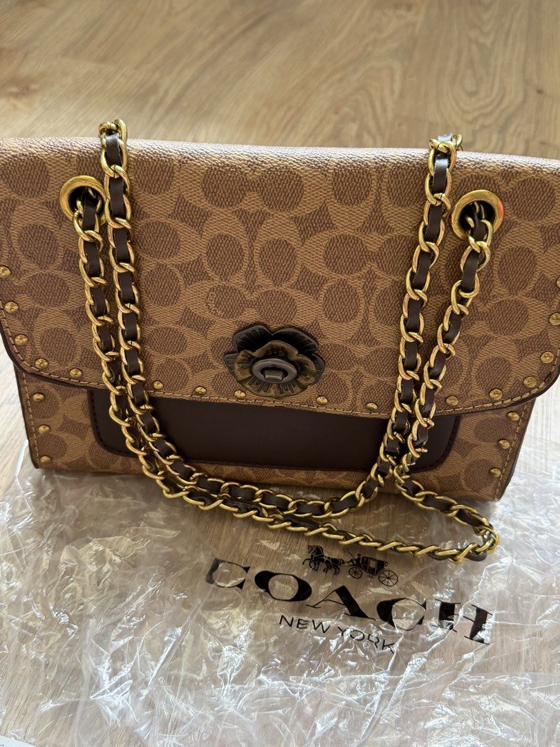 Coach Signature Chain Shoulder Bag (Category: Shoulder Bags) located in San Fernando. Submitted by somethingniceph (Listing ID 1437786495, Image 1). Description: - Coach shoulder and crossbody bag - Signature Coach pattern - chain strap - twist flower-shaped clasp - Includes an interior pocket.