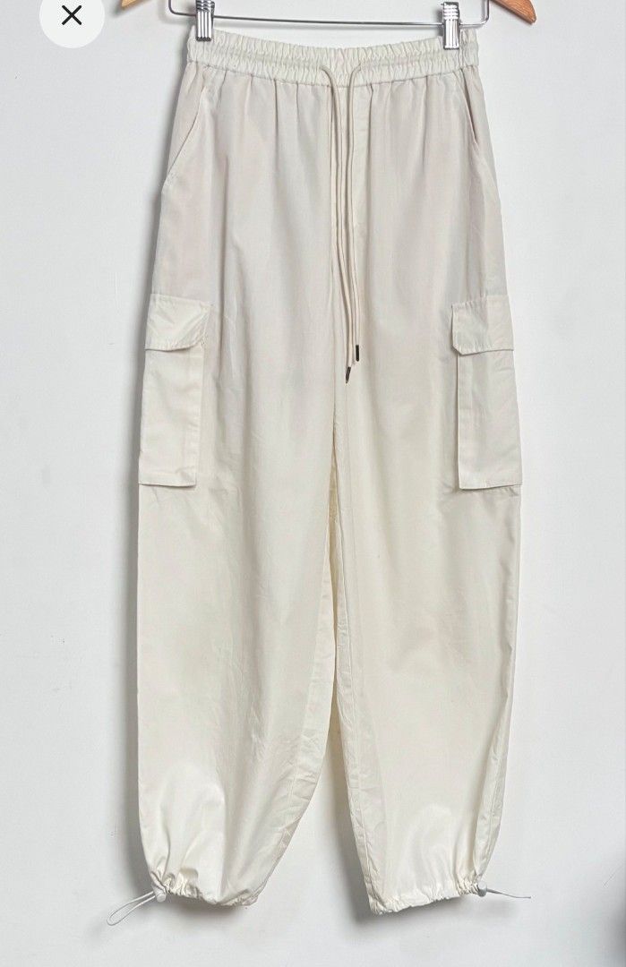 Cream Cargo Pants with Drawstring (Category: Other Bottoms) located in Guimba. Submitted by xeeeyaaaah (Listing ID 1437839429, Image 1). Description: - Cream-colored cargo pants - Relaxed fit - Drawstring waist for adjustable fit - Adjustable cuffs - Two side cargo pockets - Lightweight material - Ideal for casual wear -W24-28, L36.5.