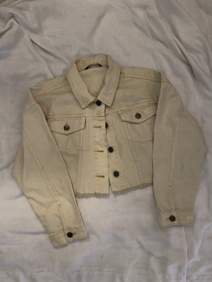 Cropped Denim Jacket (Category: Coats, Jackets and Outerwear) located in Santa Rosa. Submitted by jas_preloved21 (Listing ID 1437686986, Image 1). Description: - Cream-colored cropped denim jacket - Classic collar and button-down closure - Two chest pockets - Long sleeves with buttoned cuffs - Raw hem - Slightly distressed look - Perfect for layering.