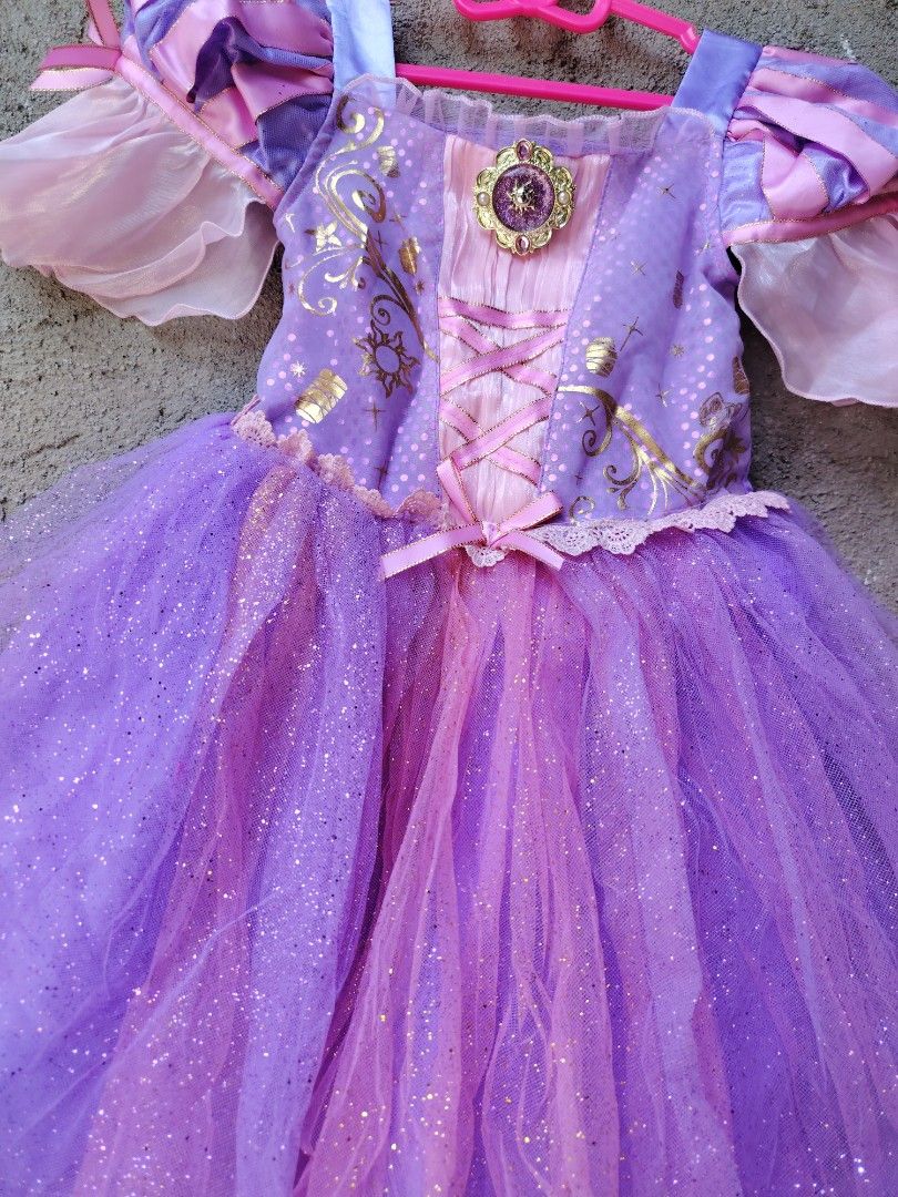 Disney Rapunzel Dress - Size 4 (Category: Babies & Kids Fashion) located in Makati City. Submitted by Prettykids (Listing ID 1437796794, Image 2). Description: - Disney Rapunzel Dress - Size: 4 (fits up to 104cm) - Colors: Purple and Pink - Glitter accents on skirt - Gold bodice detailing - Pink ribbon corset design - Includes Disney tag Original Disney Rapunzel Gown Size 4 GOOD AS NEW LOC: NUEVA ECIJA MOP:GCASH/BDO COURIER:J&T EXPRESS .