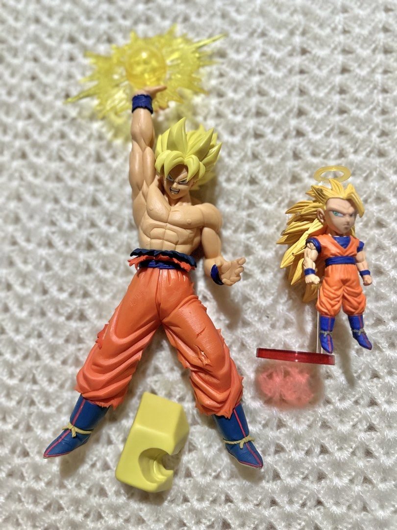 Dragon Ball Goku Figure Bundle (Category: Toys & Games) located in Davao. Submitted by favoritepreloved (Listing ID 1437915122, Image 1). Description: 💜 Brand New, no box 💜 Main figure approx. 27cm height 💜 Includes: -Large Super Saiyan Goku figure with energy effect -Mini floating Goku display figure with stand (10cm) .