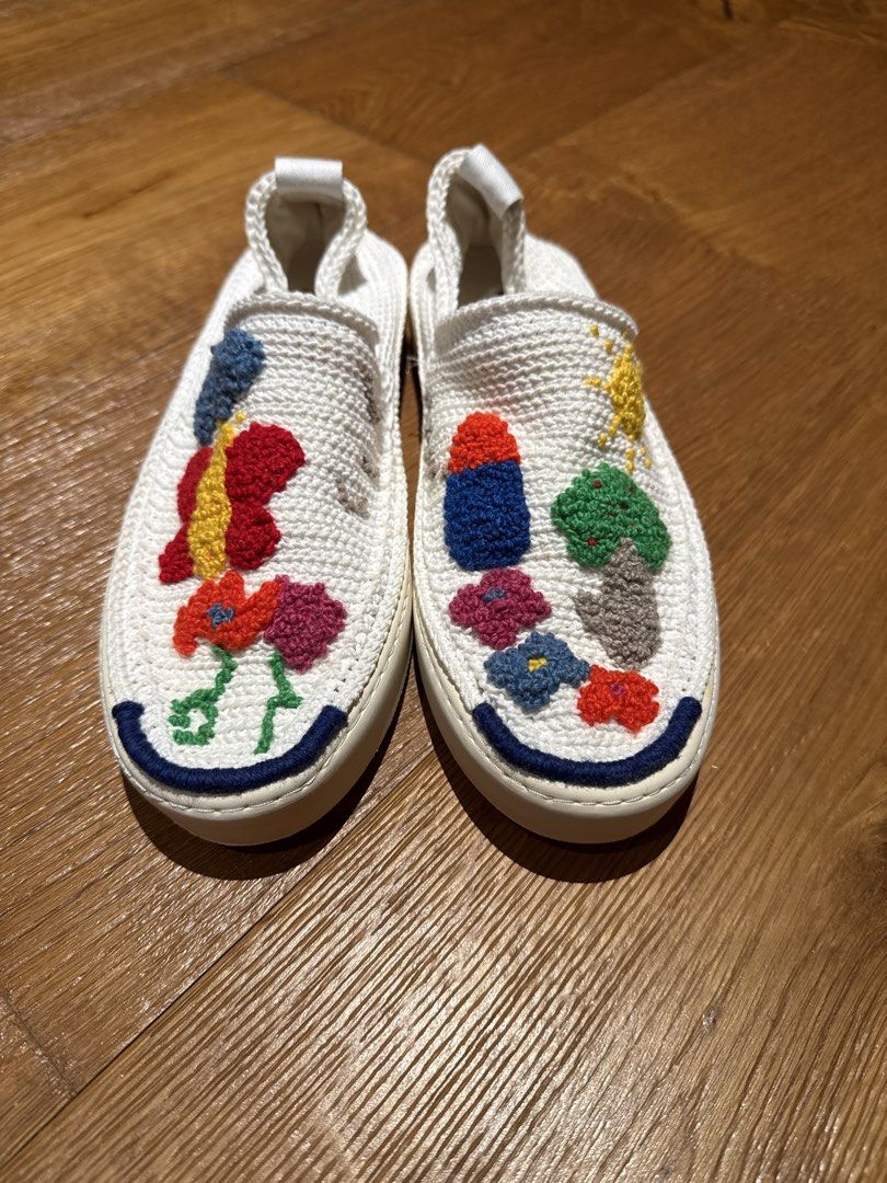 Embroidered White Slip-on Sneakers (Category: Sneakers) located in Makati City. Submitted by ral4738297 (Listing ID 1437886936, Image 1). Description: - White slip-on sneakers - Colorful embroidered designs (flowers, butterfly, abstract shapes) - Textured white fabric upper - White sole with blue trim - Pull tab at the back.