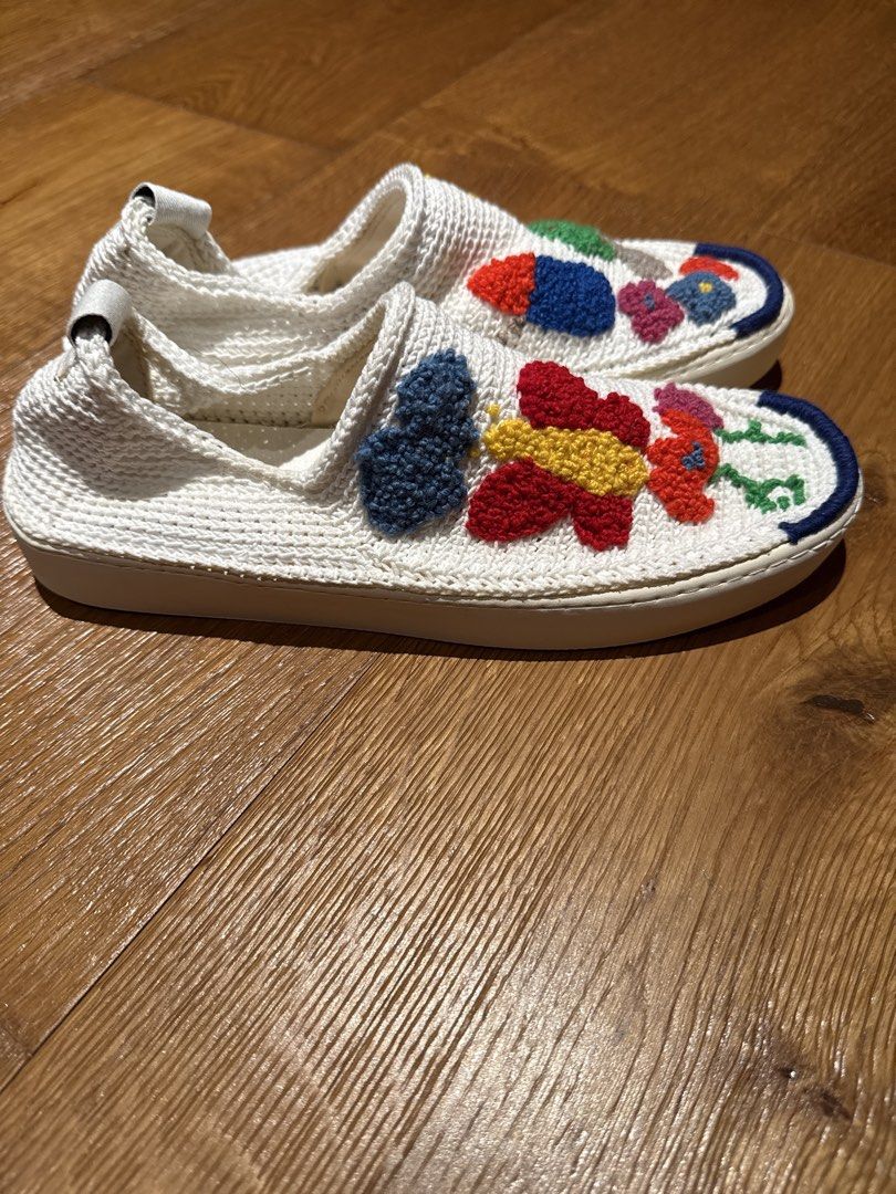 Embroidered White Slip-on Sneakers (Category: Sneakers) located in Makati City. Submitted by ral4738297 (Listing ID 1437886936, Image 2). Description: - White slip-on sneakers - Colorful embroidered designs (flowers, butterfly, abstract shapes) - Textured white fabric upper - White sole with blue trim - Pull tab at the back.