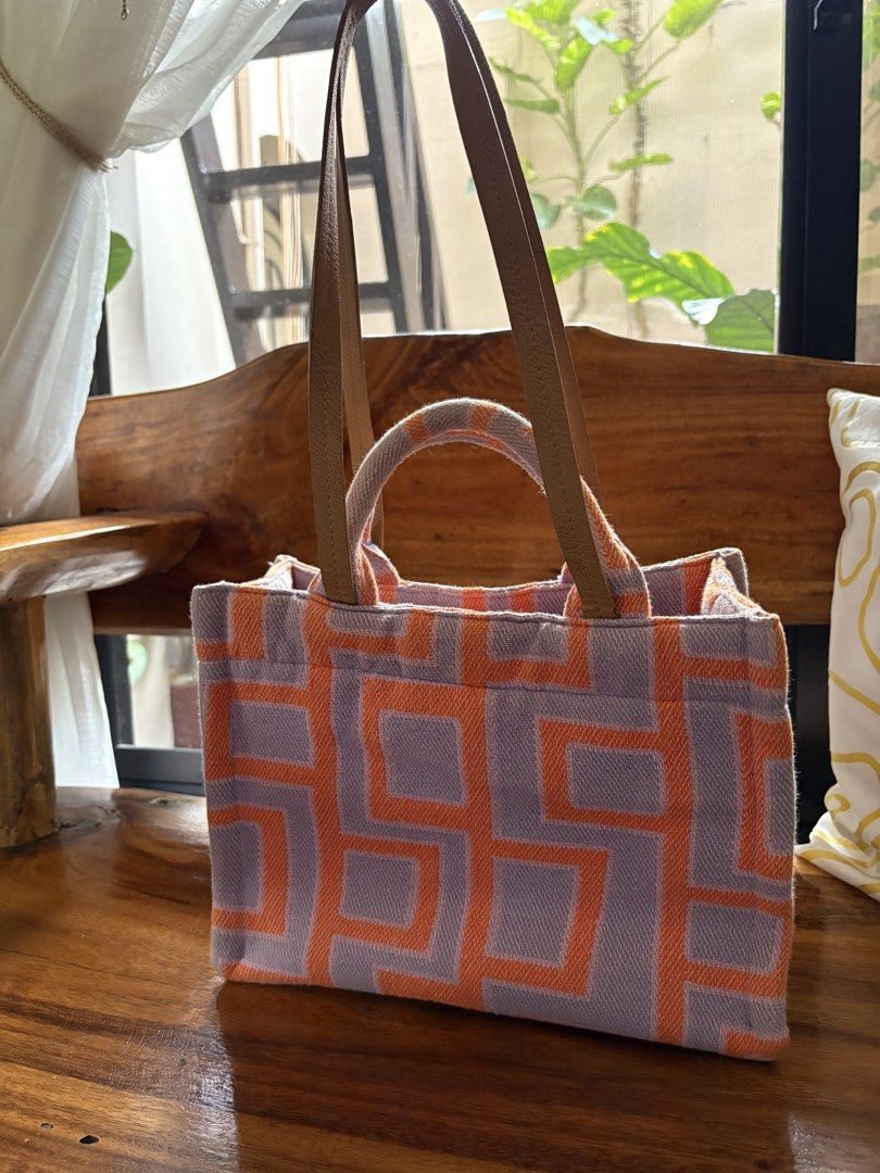 Esprit Geometric Pattern Tote Bag (Category: Tote Bags) located in Cainta. Submitted by efimoroll (Listing ID 1437761252, Image 3). Description: 👜 original Esprit tote bag perfect for summer or daily use - Unique geometric orange and purple pattern - Sturdy handles with leather accents - Magnetic snap closure .