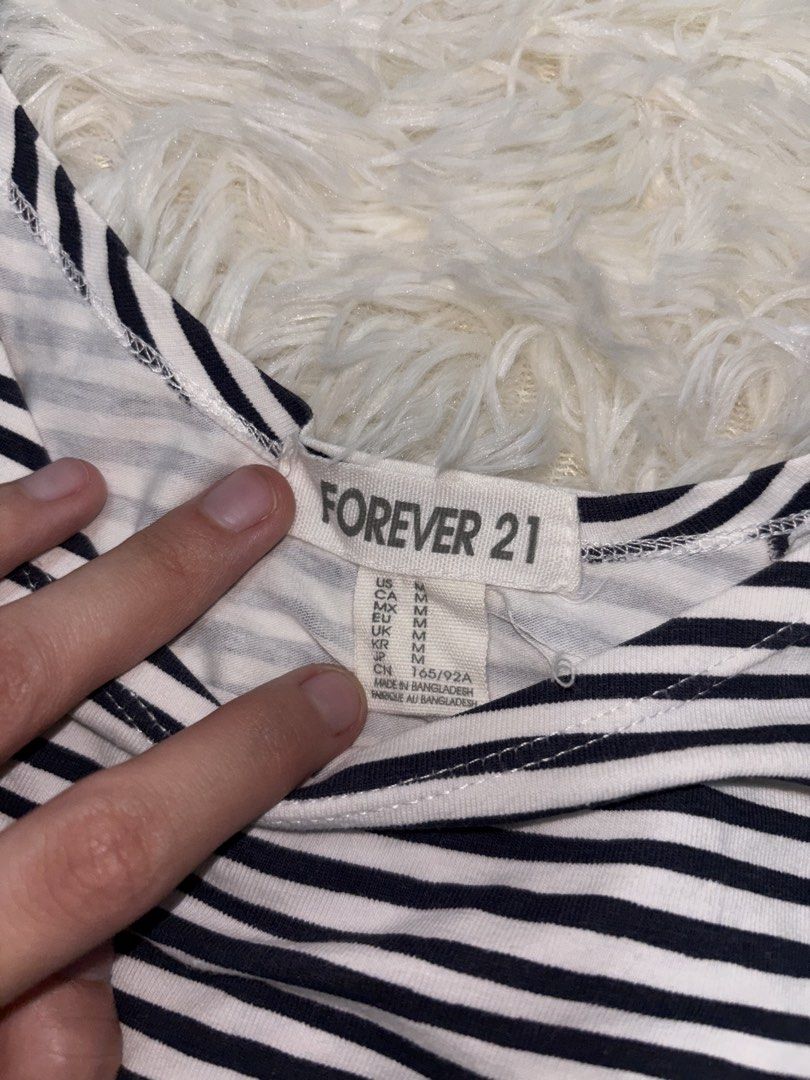 Forever 21 Striped Top - Size M (Category: Sleeveless) located in Angono. Submitted by kalidope (Listing ID 1437921455, Image 2). Description: Top from Forever 21 features a classic striped design. It has a round neckline and short sleeves. The size is M. Made in Bangladesh. The top is perfect for casual wear and can be paired with jeans or skirts. It is a versatile piece for any wardrobe..