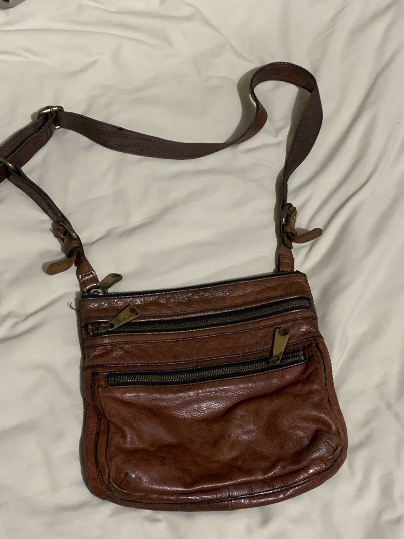 Fossil Leather Crossbody Bag (Category: Cross-body Bags) located in Makati City. Submitted by zzebraaa (Listing ID 1437783921, Image 2). Description: - Genuine Fossil crossbody bag - Rich brown leather - Multiple zippered compartments - Adjustable strap - Classic Fossil logo - Fossil logo interior lining - Stylish and practical.