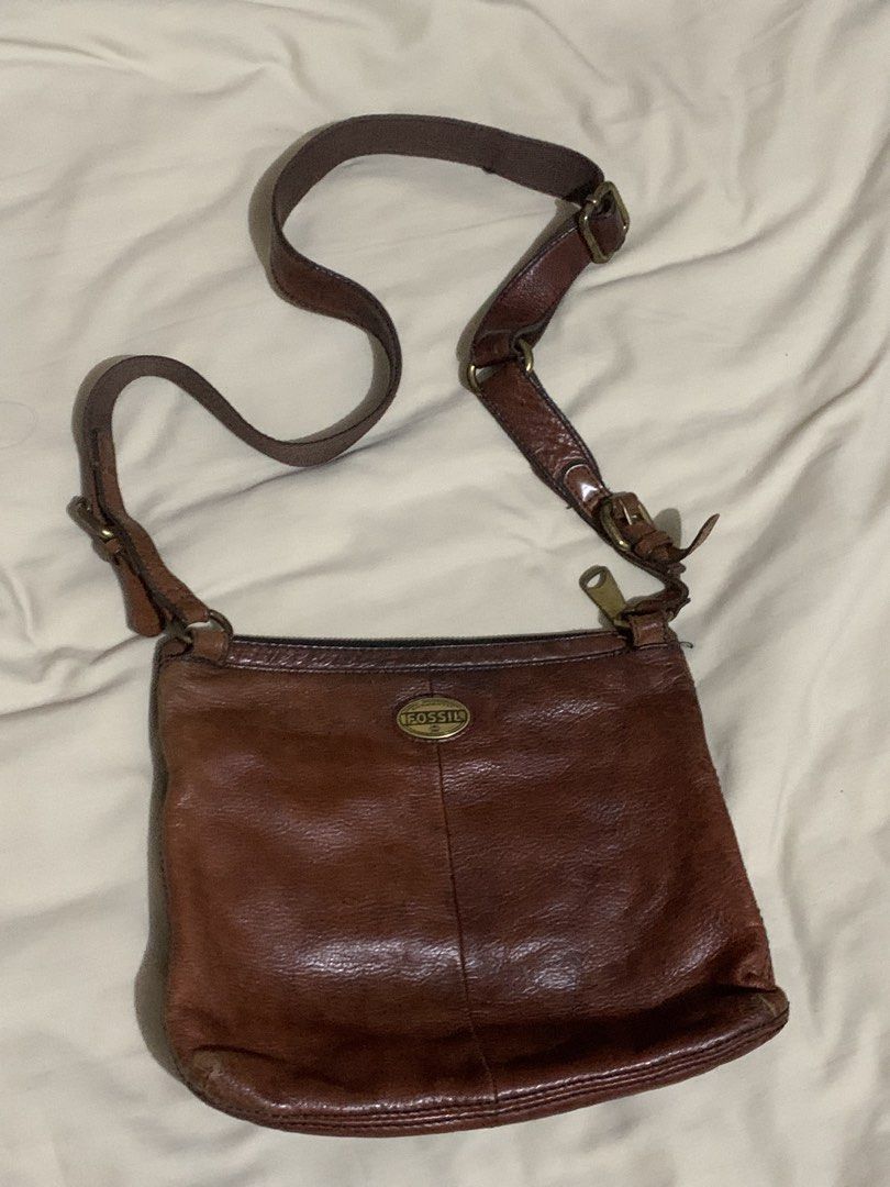 Fossil Leather Crossbody Bag (Category: Cross-body Bags) located in Makati City. Submitted by zzebraaa (Listing ID 1437783921, Image 1). Description: - Genuine Fossil crossbody bag - Rich brown leather - Multiple zippered compartments - Adjustable strap - Classic Fossil logo - Fossil logo interior lining - Stylish and practical.
