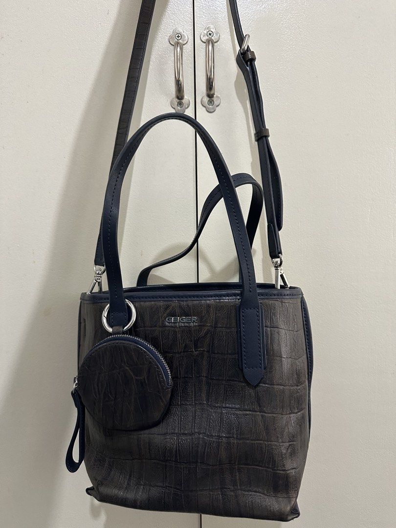Geiger Handbag with Coin Purse (Category: Cross-body Bags) located in Cebu City. Submitted by shopnsave2015 (Listing ID 1437764385, Image 2). Description: - Geiger handbag with crocodile-embossed design - Detachable coin purse included - Detachable shoulder strap - Top handle and zipper closure - Color: Brown and navy blue - Silver-tone hardware - Ideal for everyday use.