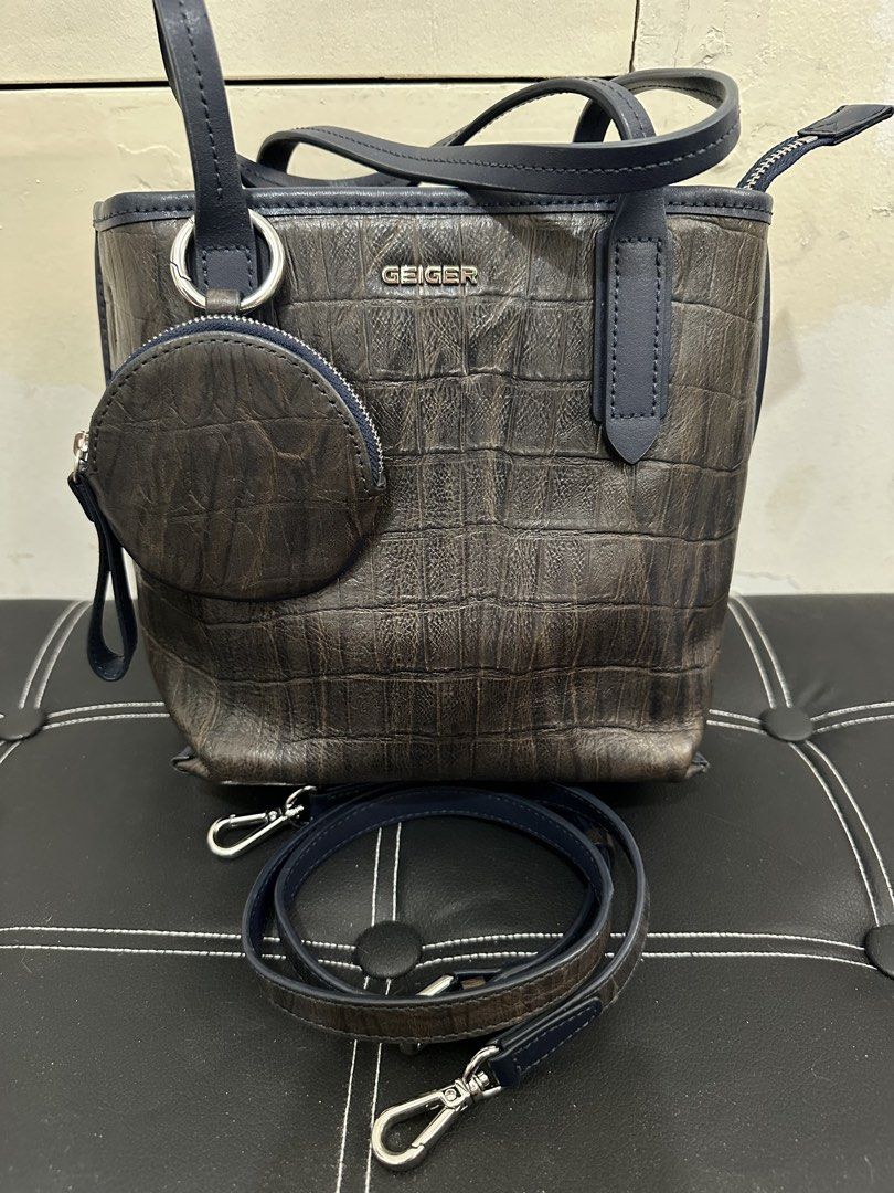 Geiger Handbag with Coin Purse (Category: Cross-body Bags) located in Cebu City. Submitted by shopnsave2015 (Listing ID 1437764385, Image 3). Description: - Geiger handbag with crocodile-embossed design - Detachable coin purse included - Detachable shoulder strap - Top handle and zipper closure - Color: Brown and navy blue - Silver-tone hardware - Ideal for everyday use.