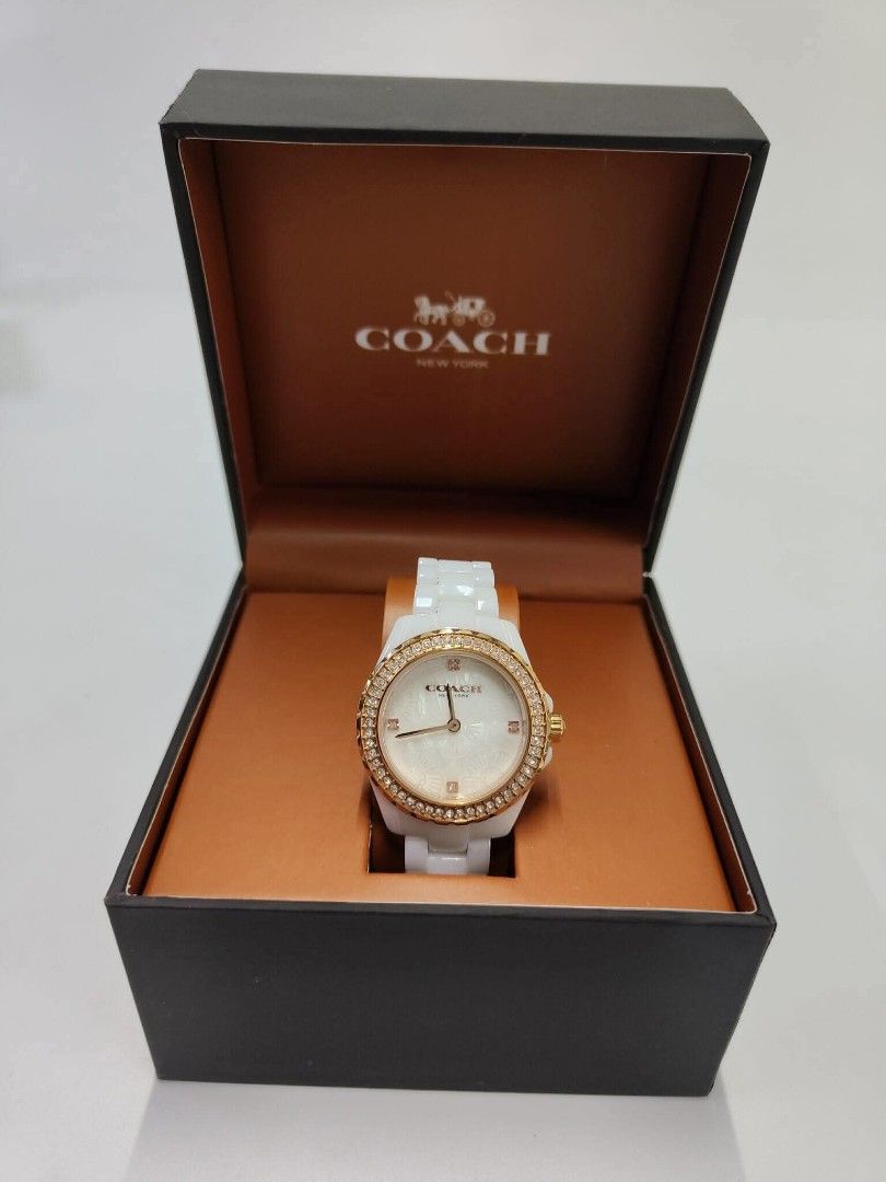 Genuine Coach Preston White Ceramic MOP Watch (Category: Women's Watches) located in Quezon City. Submitted by hollowwillow (Listing ID 1437795915, Image 1). Description: SALE! Brand new and original Coach Preston watch - white ceramic strap and gold-tone bezel - Mother-of-pearl effect watch face with sparkling crystals - Comes with the original Coach box. ⚠️ ISSUE: BOX HAS FLAWS DUE TO CARGO SHIPMENT BUT THE WATCH IS PERFECT ⚠️ STRICTLY PAYMENT 
