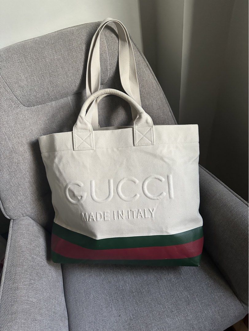 Gucci Tote Bag Ophidia (Category: Luxury Bags & Wallets) located in Butuan. Submitted by natalday (Listing ID 1437706790, Image 1). Description: - Authentic Gucci tote bag - Cream canvas body - Embossed Gucci logo - Green and red stripe detail - Two top handles - Zipper closure - Made in Italy GUCCI Canvas Logo Embossed Ophidia Tote in Beige. This stylish tote is finely crafted of canvas in beige and features red and green web striping. The top i