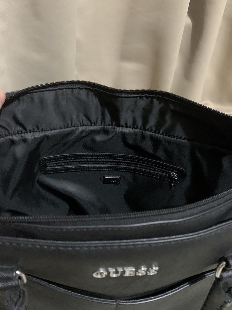 Guess Black Tote Bag (Category: Tote Bags) located in Makati City. Submitted by zzebraaa (Listing ID 1437783578, Image 2). Description: - Black Guess tote bag - Double handles - Main compartment with zipper closure - Interior zipper pocket - Two front pockets - Structured shape - Guess logo on the front - Black interior lining.