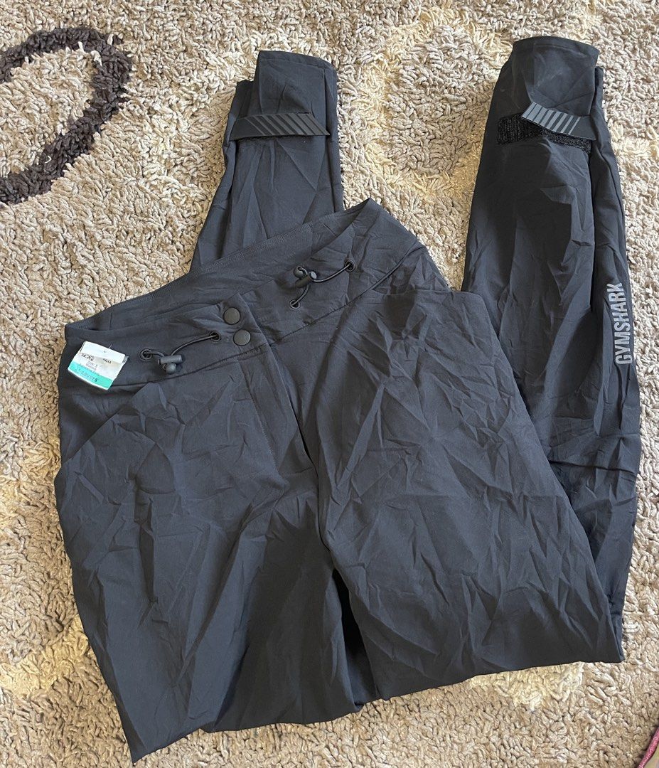 Gymshark Black XS Training Pants (Category: Activewear) located in La Trinidad. Submitted by avessonjam (Listing ID 1437875927, Image 1). Description: - Gymshark training pants - Color: Black - Size: XS - Made in Cambodia - Features: Drawstring and button closure - Design: Sleek, athletic - Suitable for: Workouts and casual wear - Material: Lightweight and durable - Gymshark logo visible.