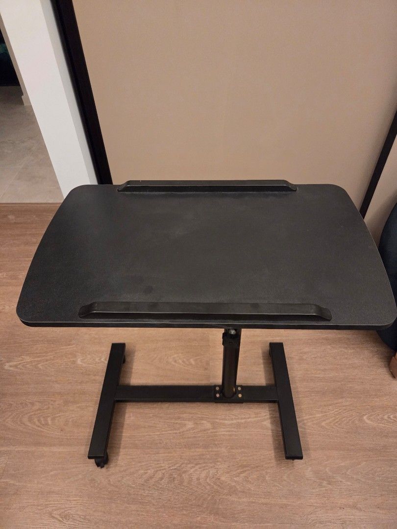 Height-Adjustable Table (Category: Tables & Sets) located in Singapore. Submitted by screamingguitar (Listing ID 1437763994, Image 1). Description: - Movable with wheels - Height adjustable 60-90cm - 55 x 32cm table top - Table top can be tilted.