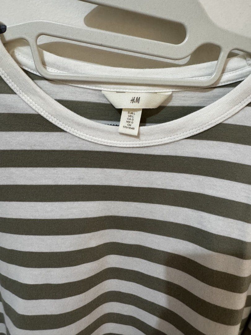 H&M Striped Long Sleeve Shirt (Category: Longsleeves) located in Quezon City. Submitted by vibelane_shop (Listing ID 1437777574, Image 2). Description: - H&M long sleeve shirt - Worn only twice - Size: L - Color: White and olive green stripes - Features: Round neckline, relaxed fit - Sleeve Length: Approximately 23 inches - Material: Lightweight - Perfect for casual wear ************ 📝This is not an online store of your favorite products. I am m
