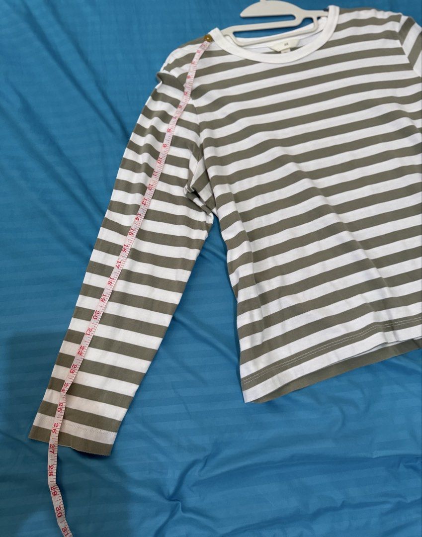 H&M Striped Long Sleeve Shirt (Category: Longsleeves) located in Quezon City. Submitted by vibelane_shop (Listing ID 1437777574, Image 3). Description: - H&M long sleeve shirt - Worn only twice - Size: L - Color: White and olive green stripes - Features: Round neckline, relaxed fit - Sleeve Length: Approximately 23 inches - Material: Lightweight - Perfect for casual wear ************ 📝This is not an online store of your favorite products. I am m