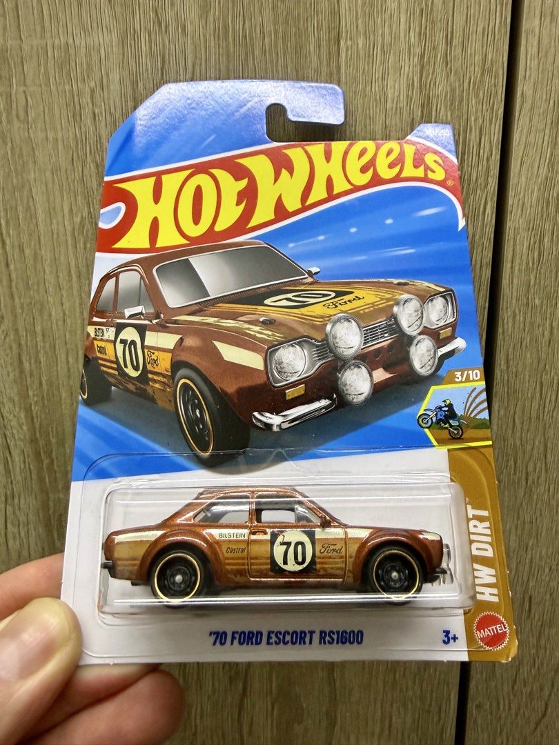 Hot Wheels '70 Ford Escort RS1600 (Category: Vehicle & Diecast Models) located in Quezon City. Submitted by walmart28 (Listing ID 1437932291, Image 2). Description: - Hot Wheels '70 Ford Escort RS1600 - HW Dirt series - Brown and gold color - Number 70 on the side - Black wheels with gold rims - Detailed front with extra lights - 3/10 in the series.