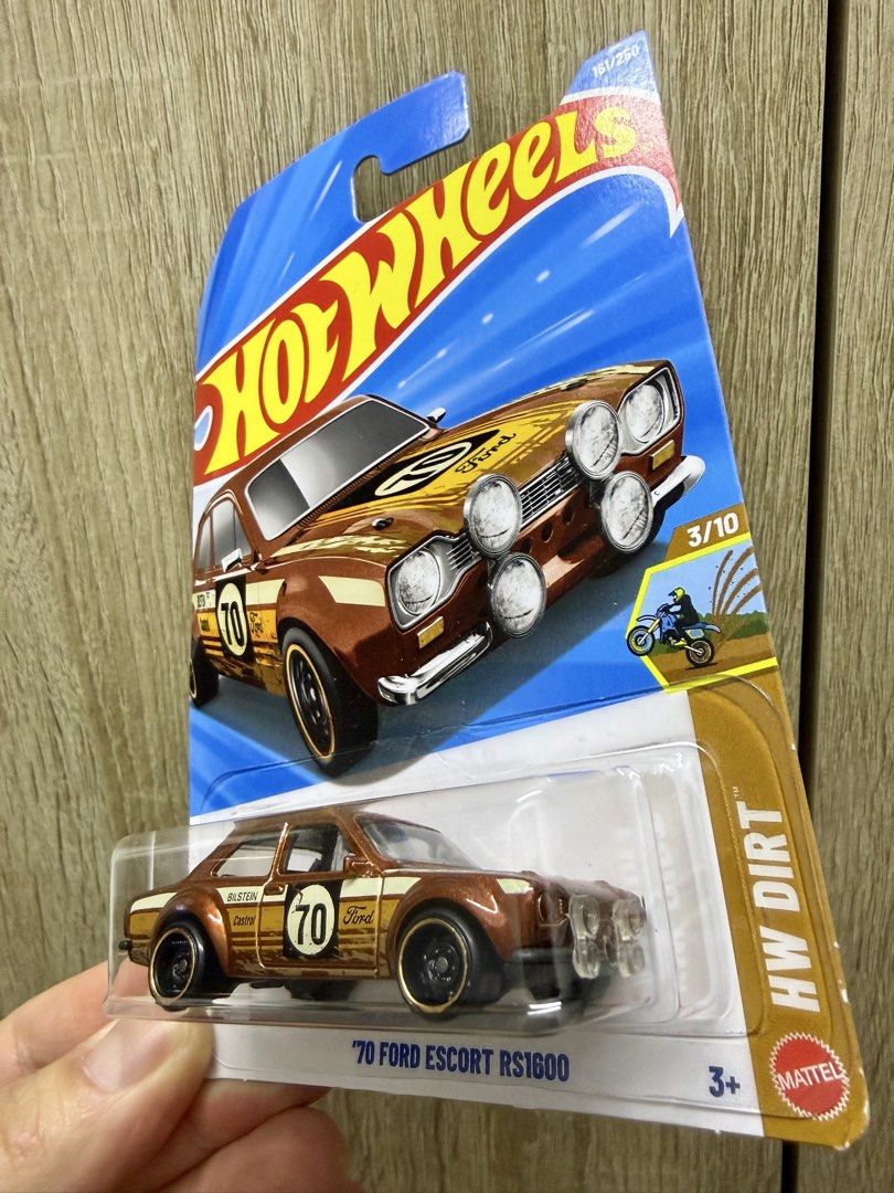 Hot Wheels '70 Ford Escort RS1600 (Category: Vehicle & Diecast Models) located in Quezon City. Submitted by walmart28 (Listing ID 1437932291, Image 3). Description: - Hot Wheels '70 Ford Escort RS1600 - HW Dirt series - Brown and gold color - Number 70 on the side - Black wheels with gold rims - Detailed front with extra lights - 3/10 in the series.