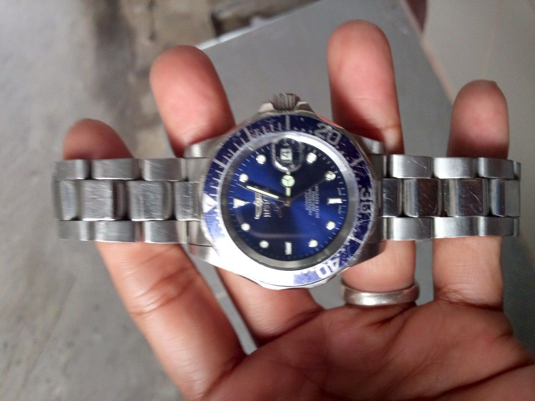 Invicta Automatic Watch with Blue Dial (Category: Men's Watches) located in Malolos. Submitted by lizarondoe59660 (Listing ID 1437817722, Image 1). Description: - Invicta automatic watch - Blue dial - Stainless steel band - Rotating bezel with blue and purple accents - Date display at 3 o'clock - Invicta logo on clasp - Water resistant.