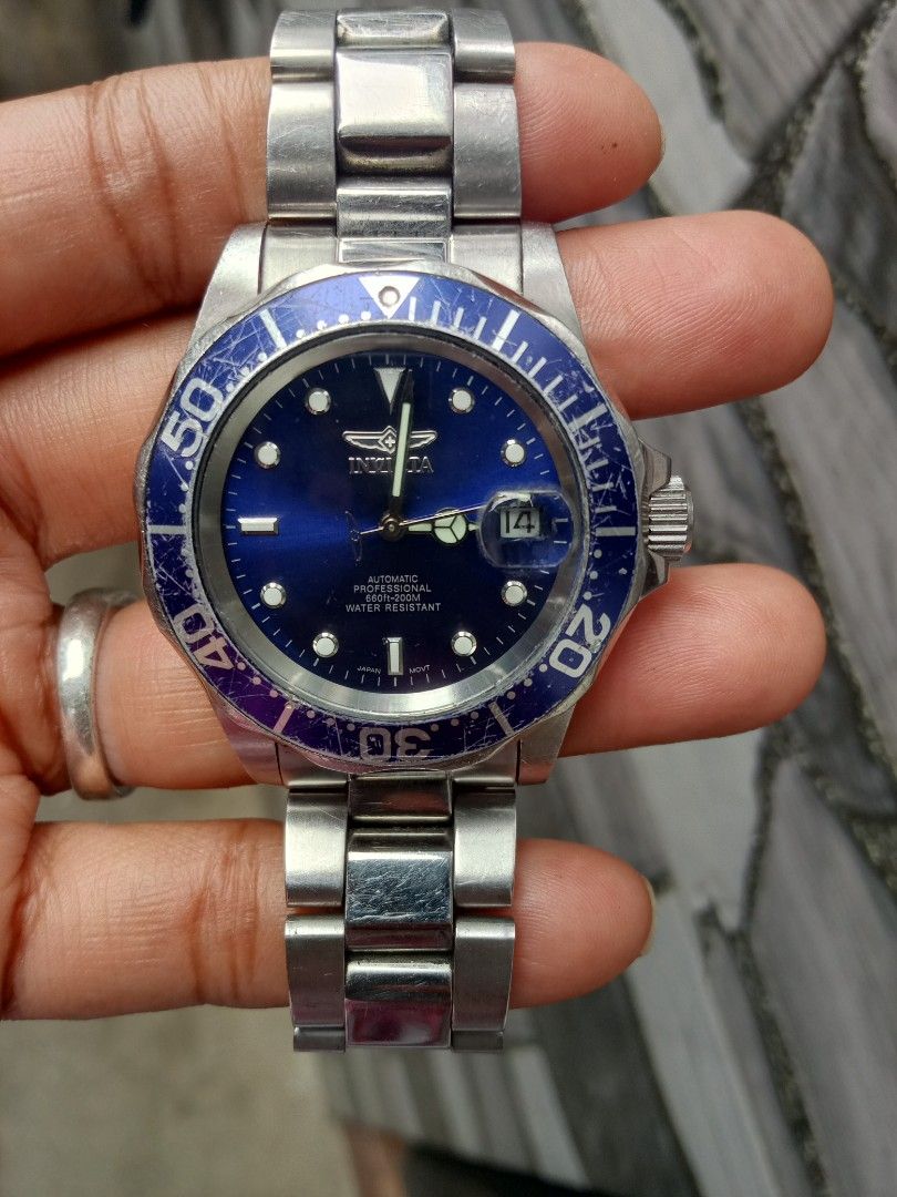 Invicta Automatic Watch with Blue Dial (Category: Men's Watches) located in Malolos. Submitted by lizarondoe59660 (Listing ID 1437817722, Image 3). Description: - Invicta automatic watch - Blue dial - Stainless steel band - Rotating bezel with blue and purple accents - Date display at 3 o'clock - Invicta logo on clasp - Water resistant.