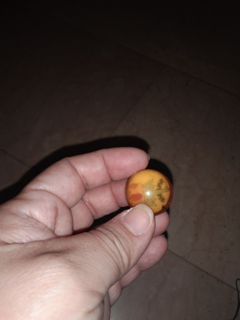 Jackstone ball king adventure time (Category: Vintage Collectibles) located in Quezon City. Submitted by eidorableshop (Listing ID 1437928516, Image 2). Description: - Vintage marble - Unique marbled design - Colors: Orange, yellow, and brown - Round shape - Glass-like appearance - Classic toy or collectible item.