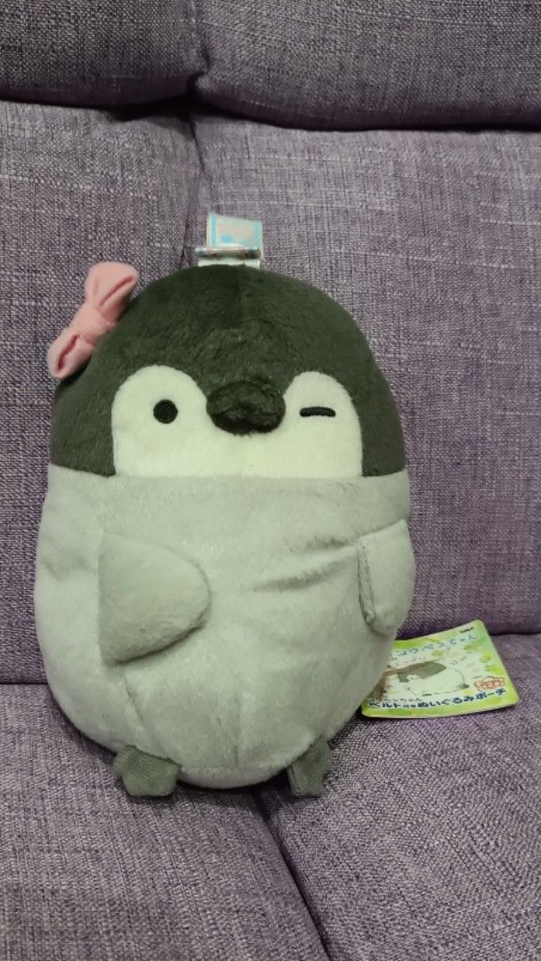 Koupen Chan Penguin Plush Toy with Pink Bow (Category: Toys & Games) located in Quezon City. Submitted by fabricatebycp (Listing ID 1437898712, Image 1). Description: Adorable penguin plush toy featuring a cute pink bow. It has a zipper on the back. The toy is gray and black in color. It comes with a tag attached. The plush toy is small and can be used as a keychain..