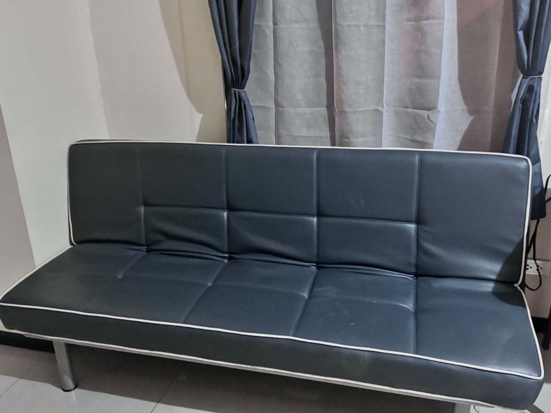 Leather Sofa bed (Category: Sofas) located in Manila. Submitted by jezm. (Listing ID 1437769353, Image 1). Description: - Black leatherette sofa bed with white piping - Features a tufted design - Rectangular shape - Sturdy metal legs - Converts easily from sofa to bed - Ideal for small living spaces.