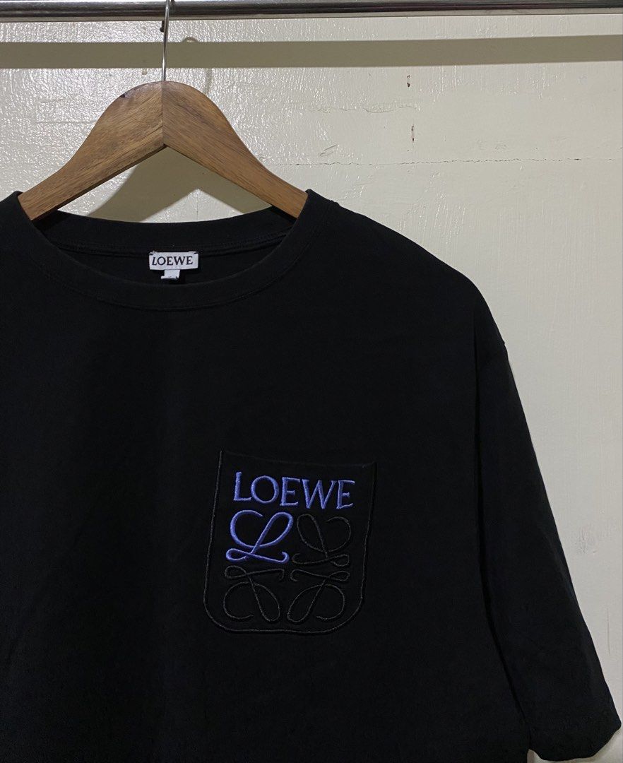 Loewe Embroidered Pocket T-shirt (Category: Tshirts & Polo Shirts ) located in Manila. Submitted by donskehh (Listing ID 1437903419, Image 3). Description: - Loewe Black T-shirt - Crew neck and short sleeves - Embroidered pocket with blue Loewe logo - Size: M - Material: 100% Cotton - Dimensions 24by29 - Brand new Condition .