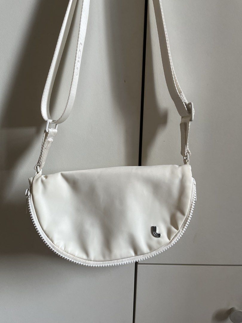Lole Crossbody Bag (Category: Cross-body Bags) located in Manila. Submitted by book.archives (Listing ID 1437796692, Image 1). Description: - Lole crossbody bag in white - Main compartment with magnetic snap closure - Interior zippered pocket - Adjustable strap - Exterior zippered pocket on the back - Water-resistant material.