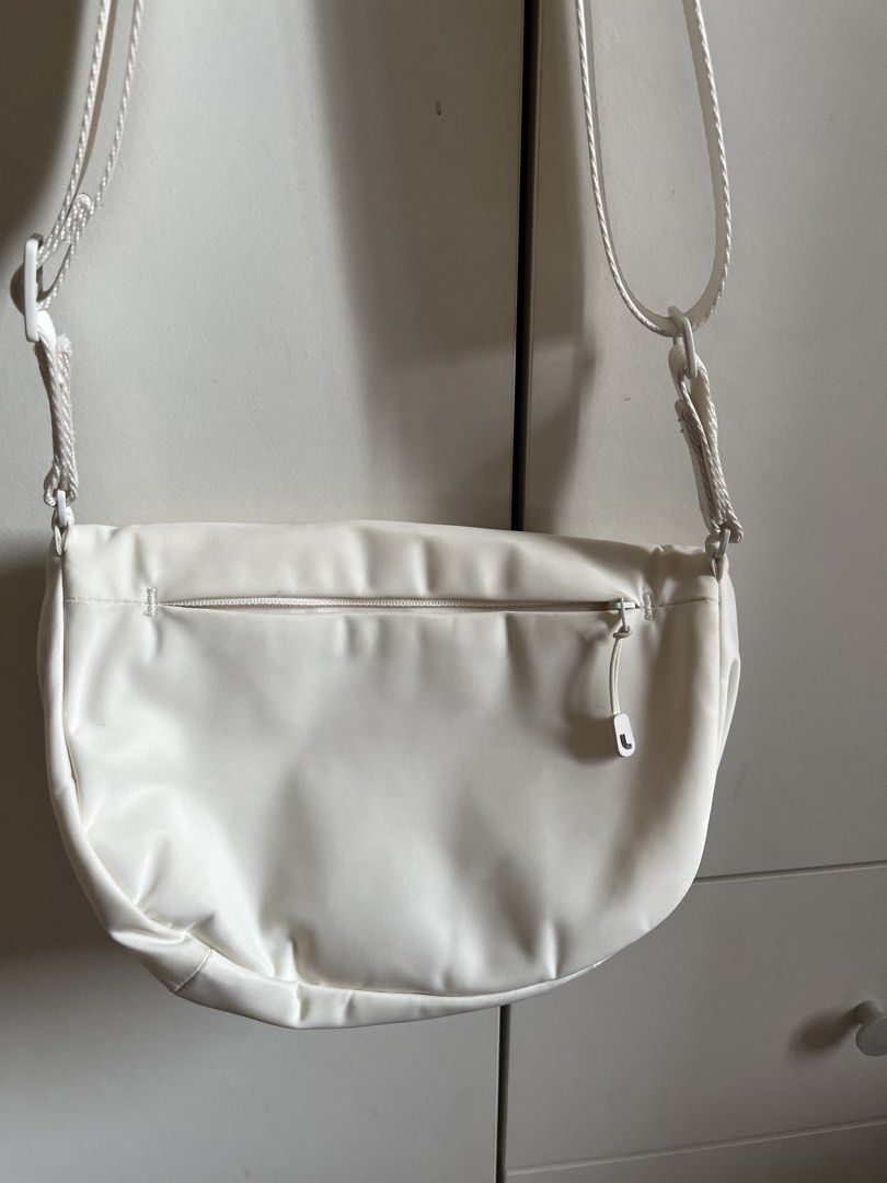 Lole Crossbody Bag (Category: Cross-body Bags) located in Manila. Submitted by book.archives (Listing ID 1437796692, Image 3). Description: - Lole crossbody bag in white - Main compartment with magnetic snap closure - Interior zippered pocket - Adjustable strap - Exterior zippered pocket on the back - Water-resistant material.