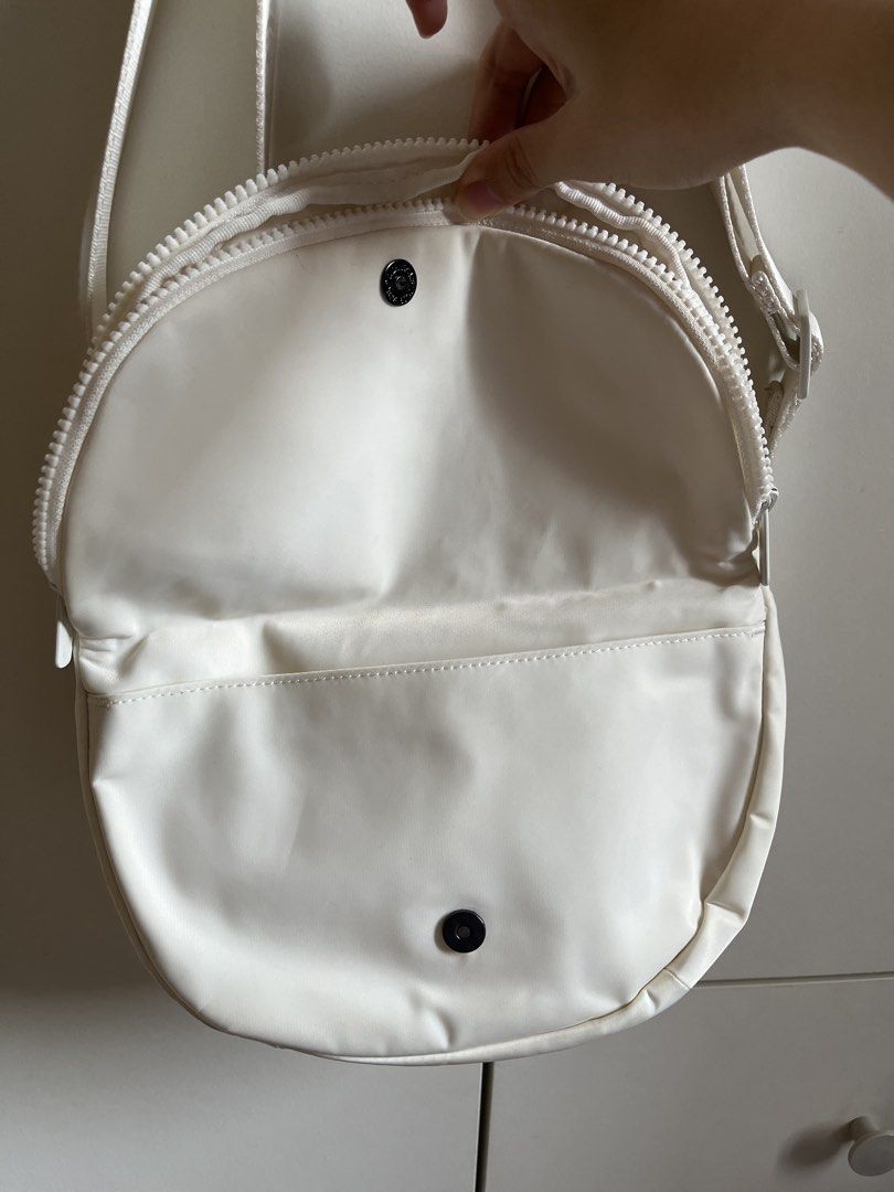 Lole Crossbody Bag (Category: Cross-body Bags) located in Manila. Submitted by book.archives (Listing ID 1437796692, Image 2). Description: - Lole crossbody bag in white - Main compartment with magnetic snap closure - Interior zippered pocket - Adjustable strap - Exterior zippered pocket on the back - Water-resistant material.